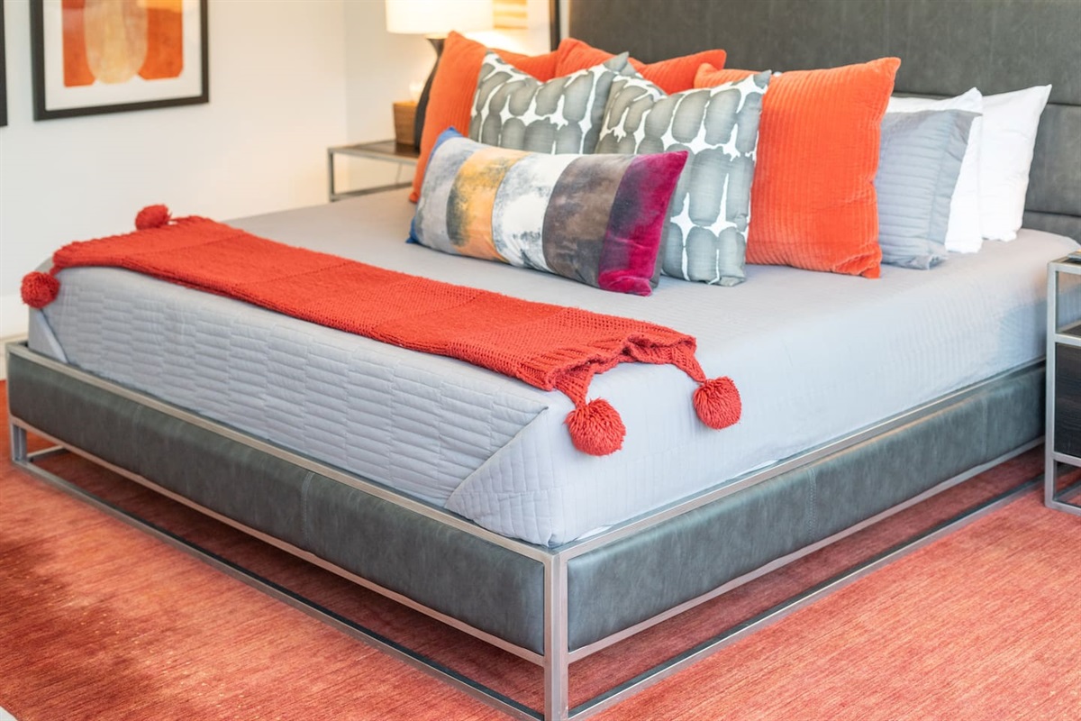 The king-size bed’s luxe frame and detailed bedding bring warmth and sophistication to this elegant desert hideaway.

