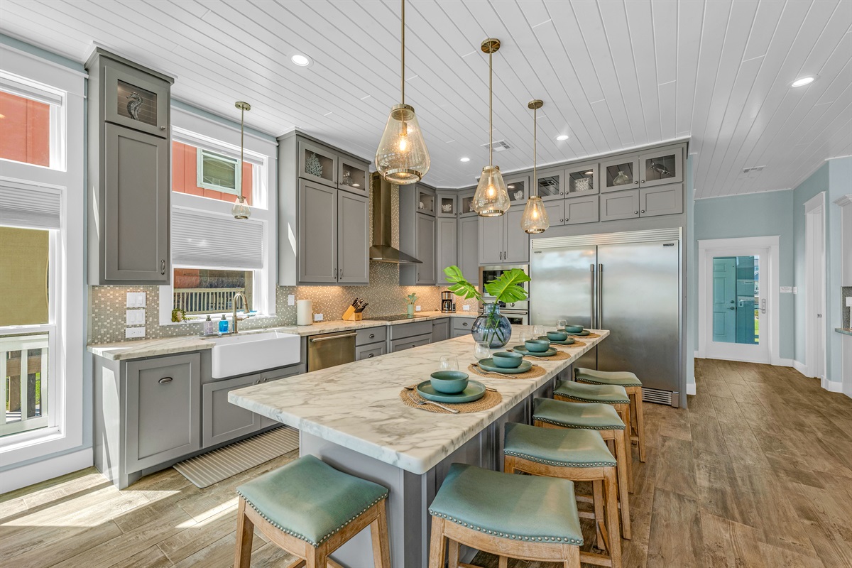 Crystal Paradise Kitchen: Cook, dine, and connect in a spacious kitchen featuring luxurious marble countertops and airy design.