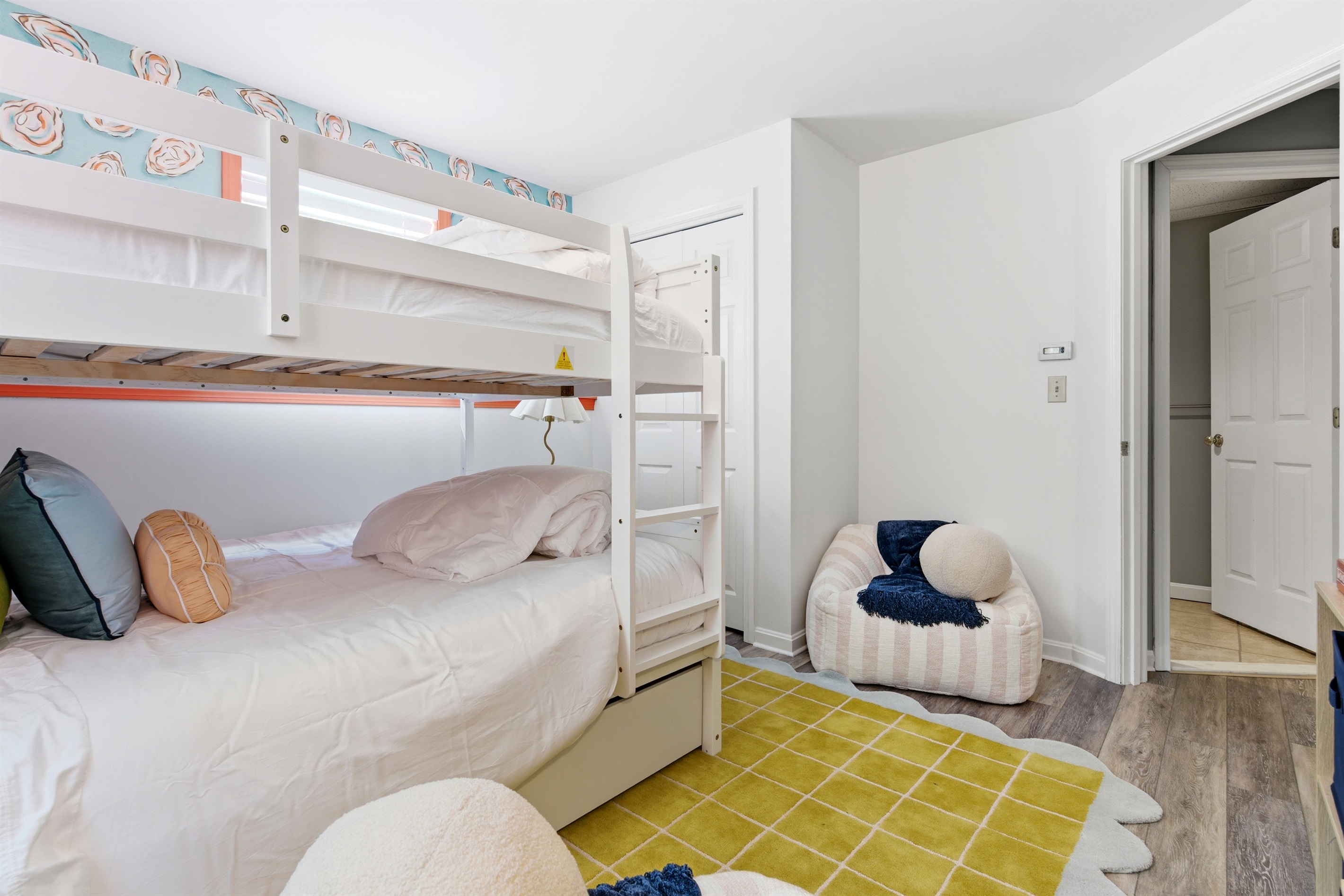 A fun and inviting room featuring cozy bean bags for lounging and a convenient closet for storage, combining comfort and functionality in a relaxed space.