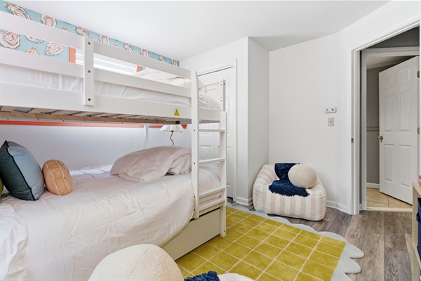A fun and inviting room featuring cozy bean bags for lounging and a convenient closet for storage, combining comfort and functionality in a relaxed space.