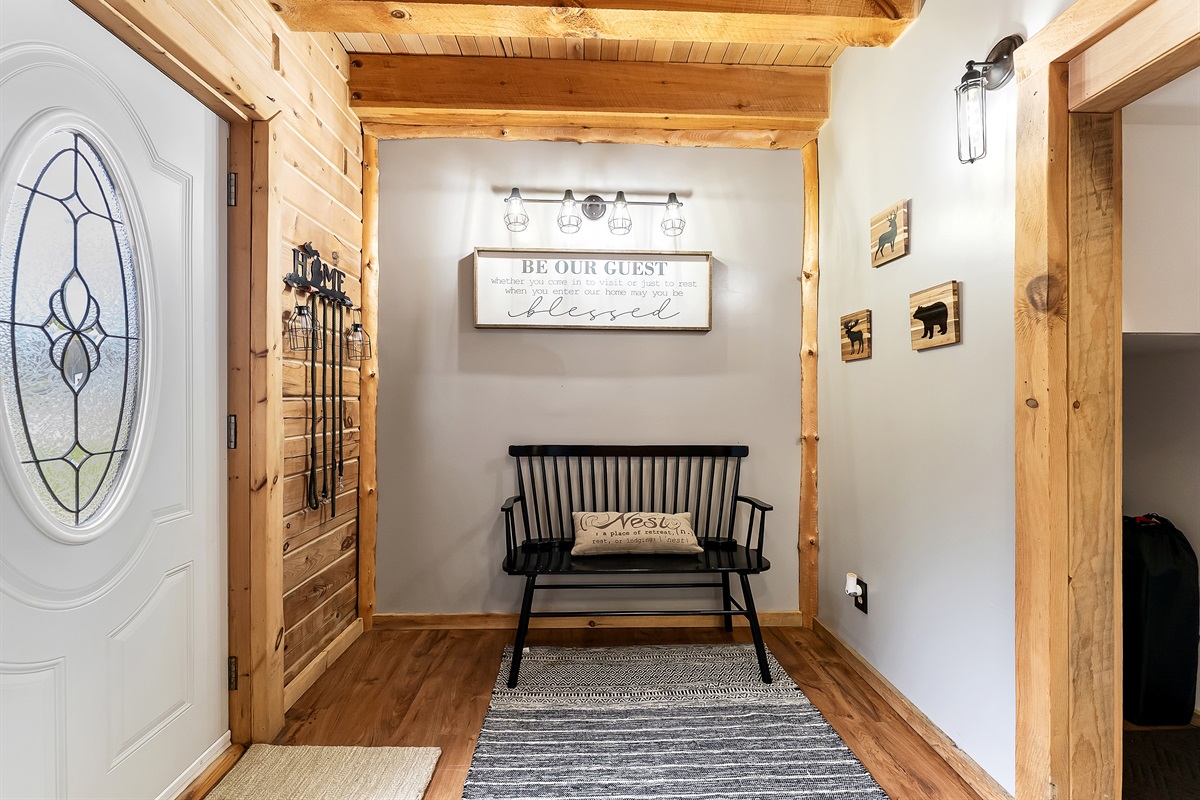 Entry door, bench, and closet to store coats.