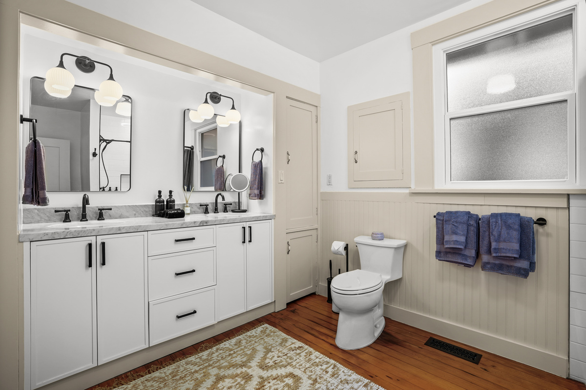 The newly renovated full bathroom downstairs features a double vanity and a bathtub, offering a bright, modern space that's perfect for getting ready or unwinding after a day of exploring Napa Valley.