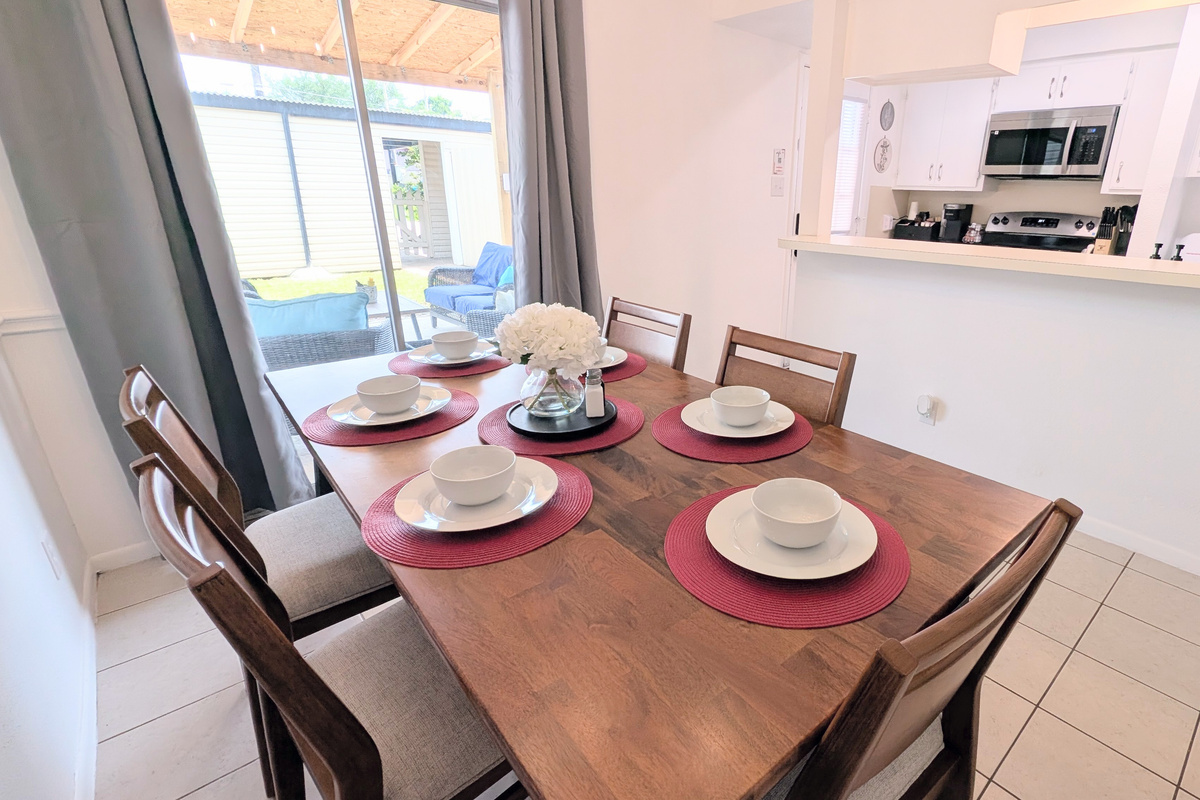 Enjoy easy access from the dining room to the charming outdoor courtyard and well-equipped galley kitchen.