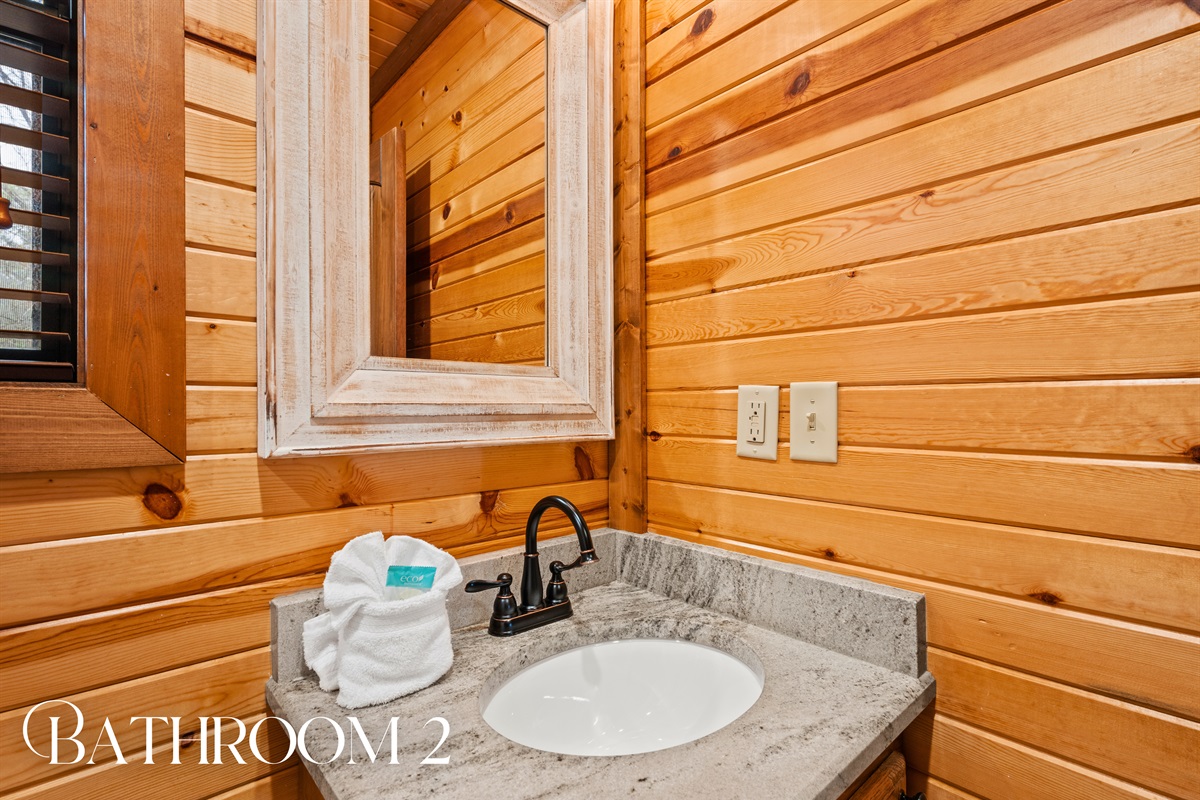 The second bathroom includes a simple yet functional vanity, providing everything you need for everyday comfort.