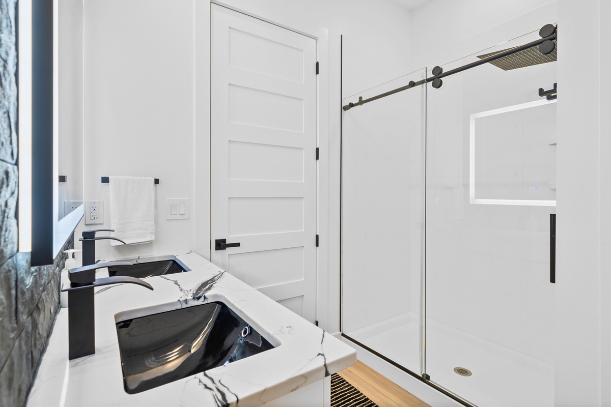 Start your day in this modern bathroom with sleek fixtures and a spacious shower.