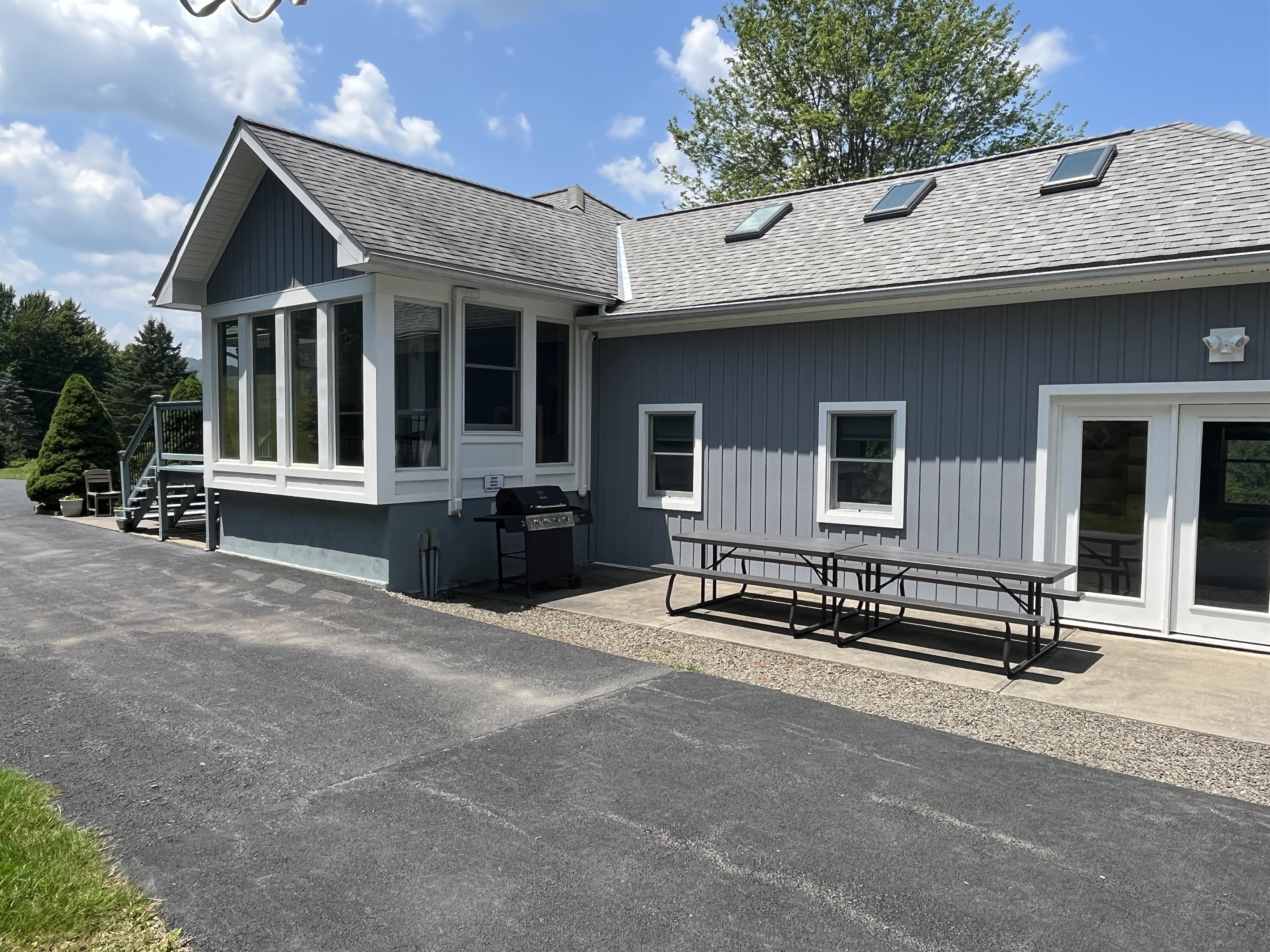 Shagbark Hill back area with outdoor dining and grill area.