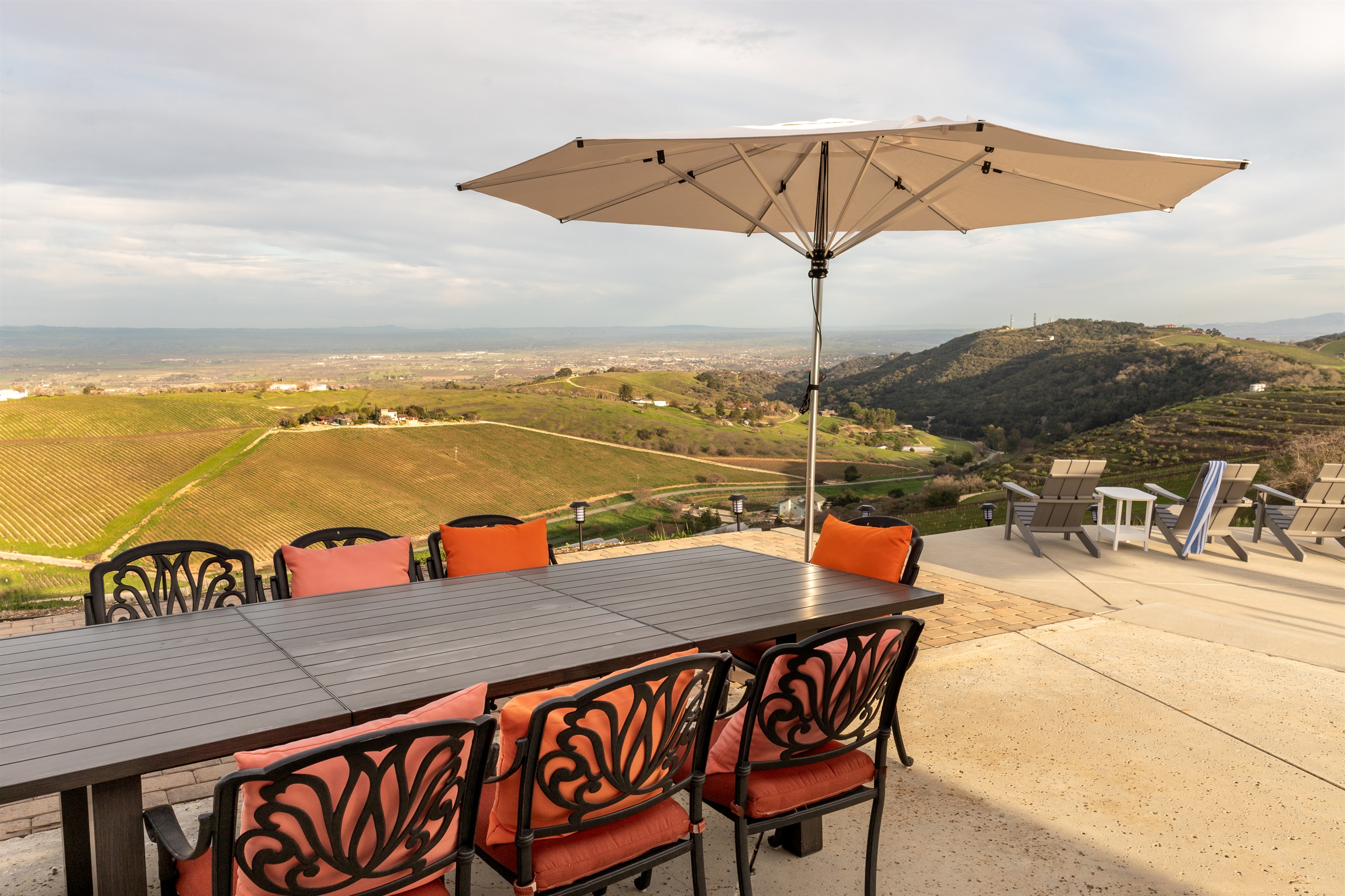The afternoon light settles over the Adelaida District as the outdoor table waits for its next gathering. Ten seats, one view, infinite reasons to linger.