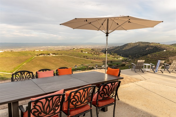 The afternoon light settles over the Adelaida District as the outdoor table waits for its next gathering. Ten seats, one view, infinite reasons to linger.