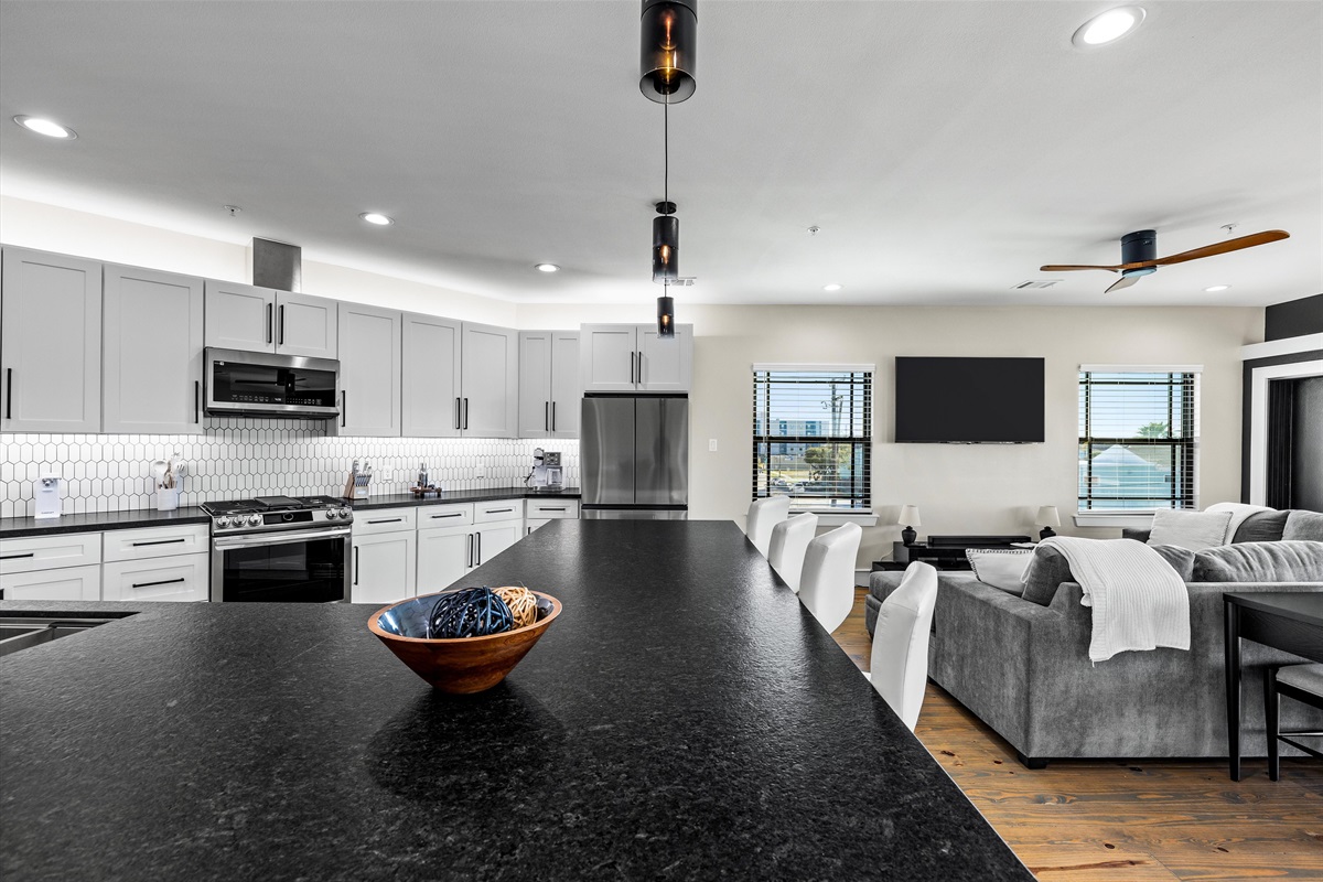 Kitchen & Living Area: Entertain effortlessly in this modern space with sleek finishes and inviting light!