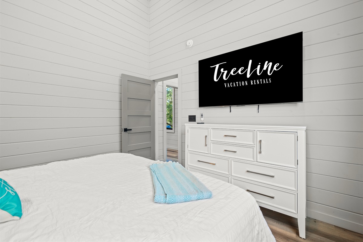 The soft blue hues and simple elegance of this space create a restful haven ideal for lazy mornings or quiet evenings.