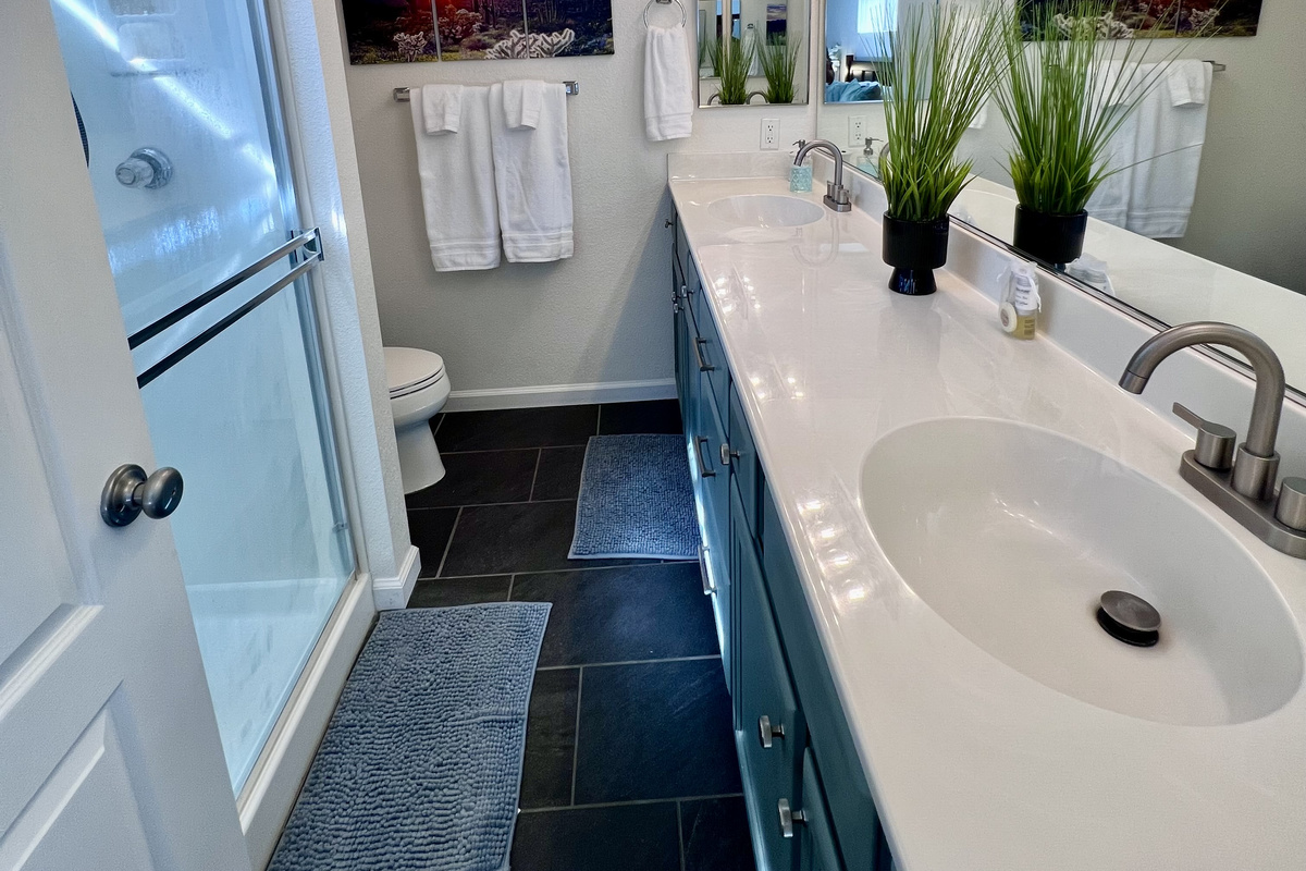 The master bathroom features dual sinks and ample counter space, perfect for couples or those who appreciate extra room to spread out