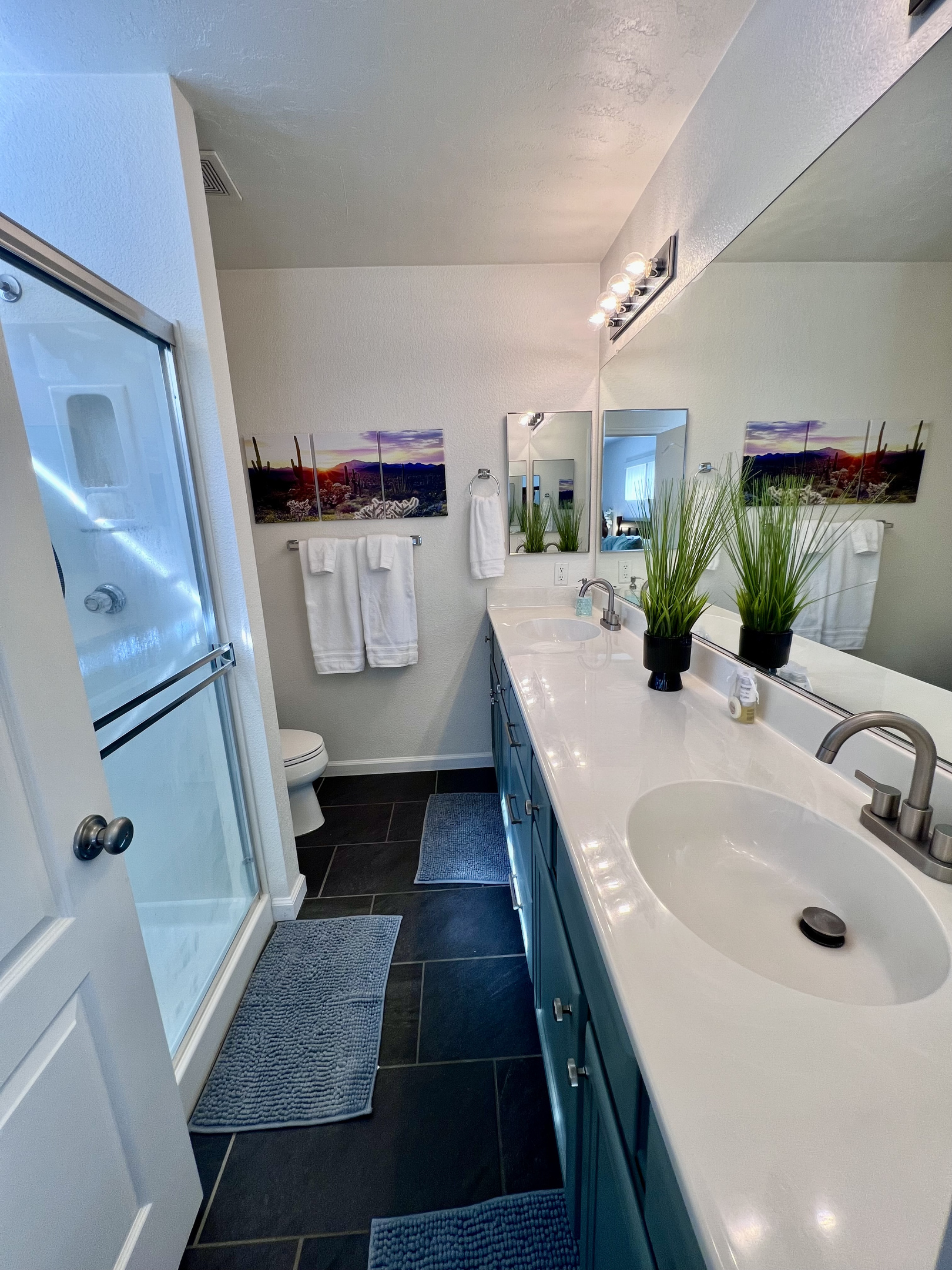 The master bathroom features dual sinks and ample counter space, perfect for couples or those who appreciate extra room to spread out