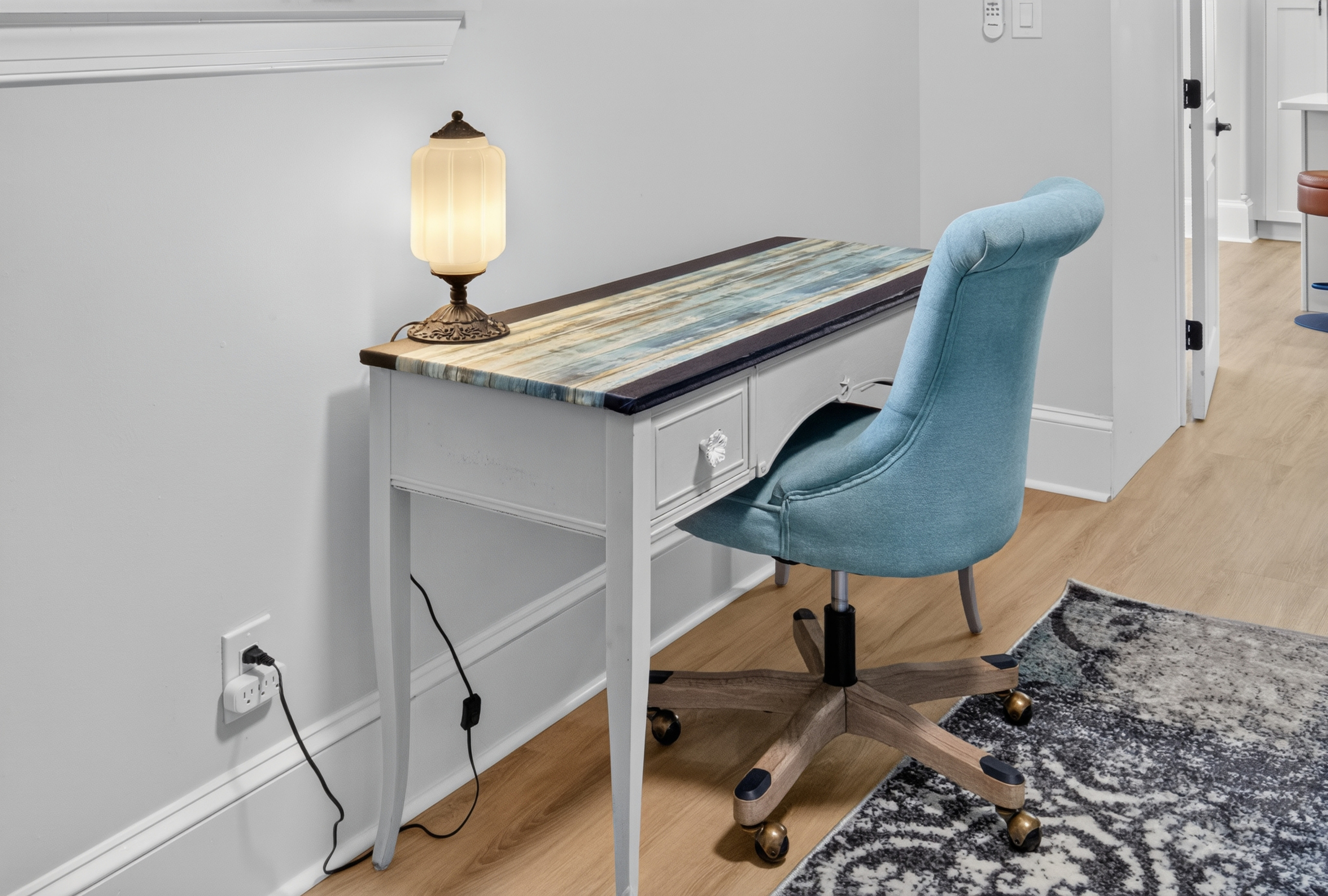 Second dedicated workspace in Bedroom 3 with desk lamp, comfortable seating, and multi-port charging.