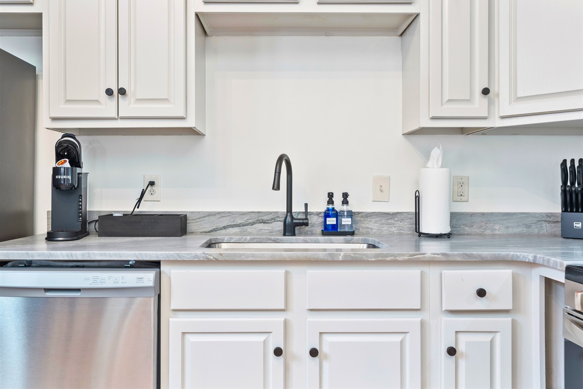 The kitchen sink area pairs style with practicality, featuring a Keurig coffee maker and everything you need for your morning routine.