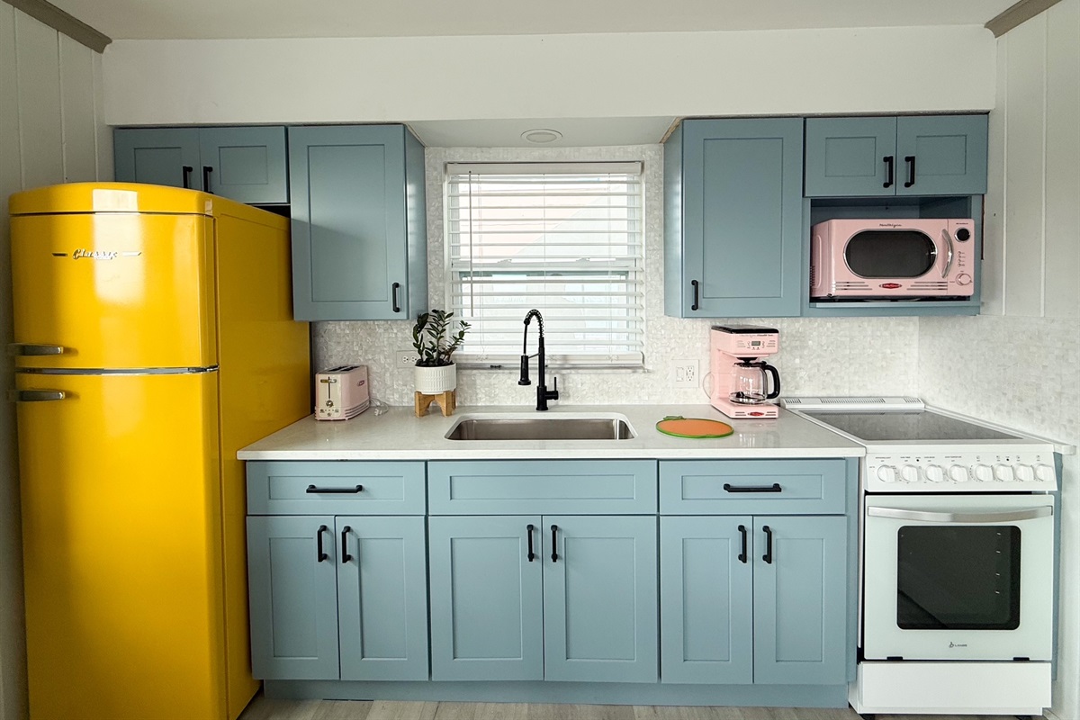 Retro Yellow Fridge, Pink Microwave, Pale Blue Kitchen Cabinets