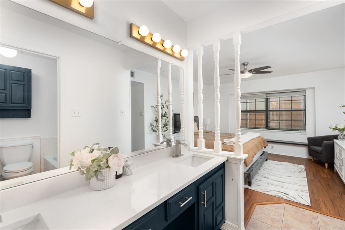Relax in this spacious bedroom with natural light and modern decor.