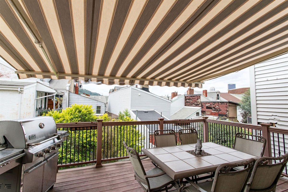 Relaxing back porch with a cozy seating area, complemented by a handy shed for additional storage or outdoor items.