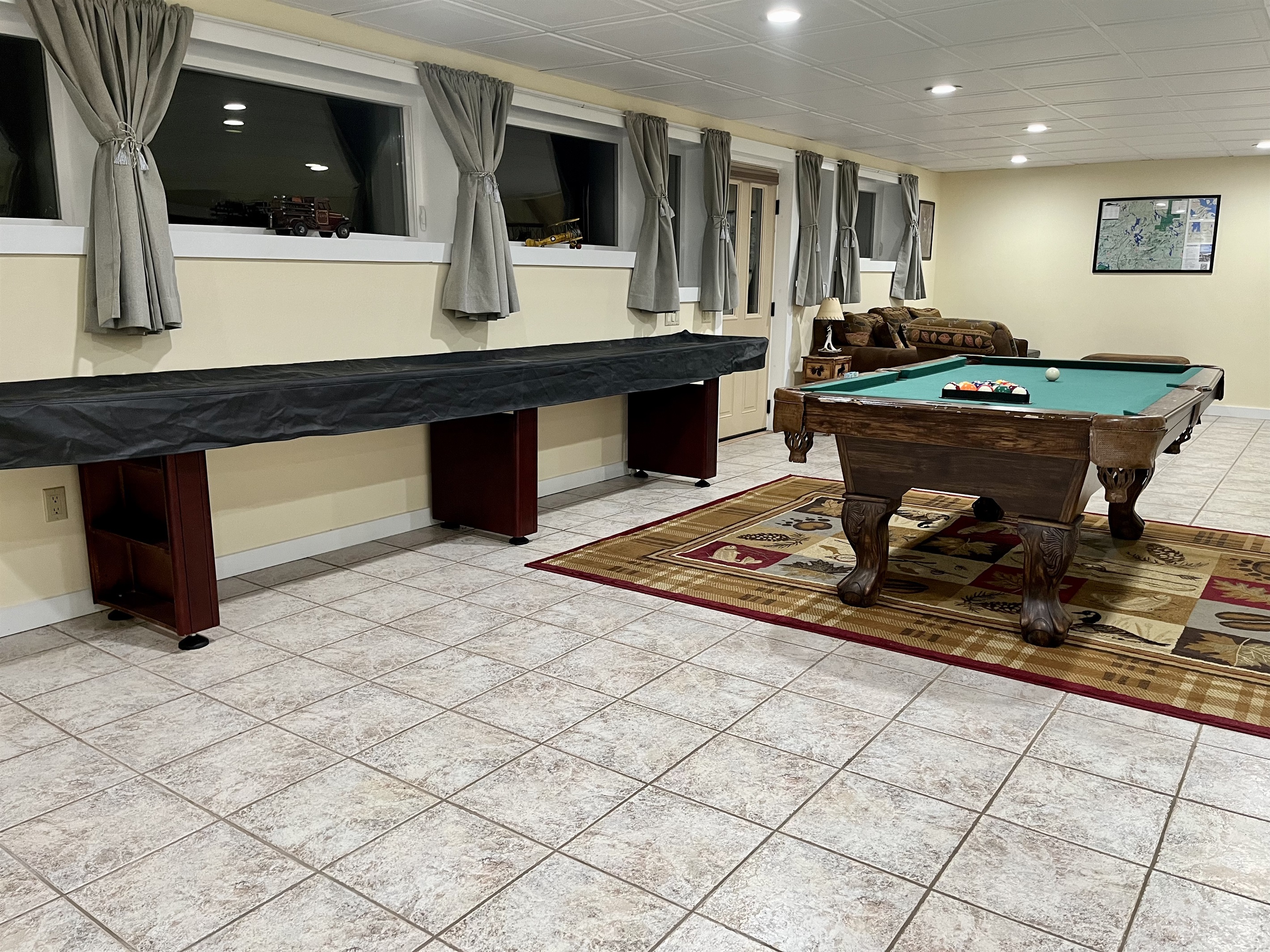 Game room: pool table, ping pong table, shuffleboard table, games, TV, sleeper sofa.