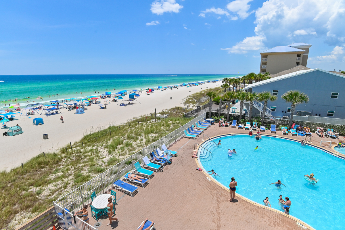Patio is overlooking the Pool and the Beach!  - this photo is from peak season in June - plenty of beach and pool for everyone!