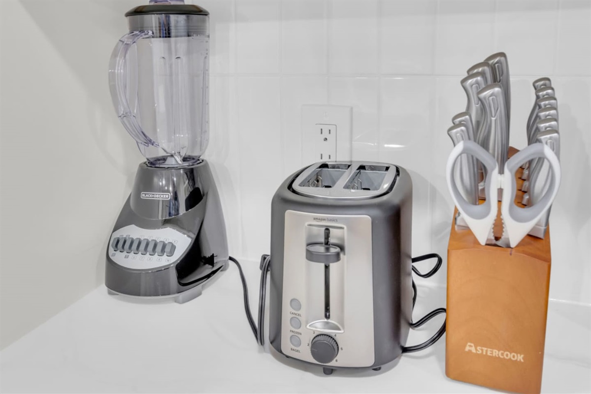 Countertop essentials include a blender, toaster, and full knife block. Perfect for quick breakfasts and convenient in-home meals.