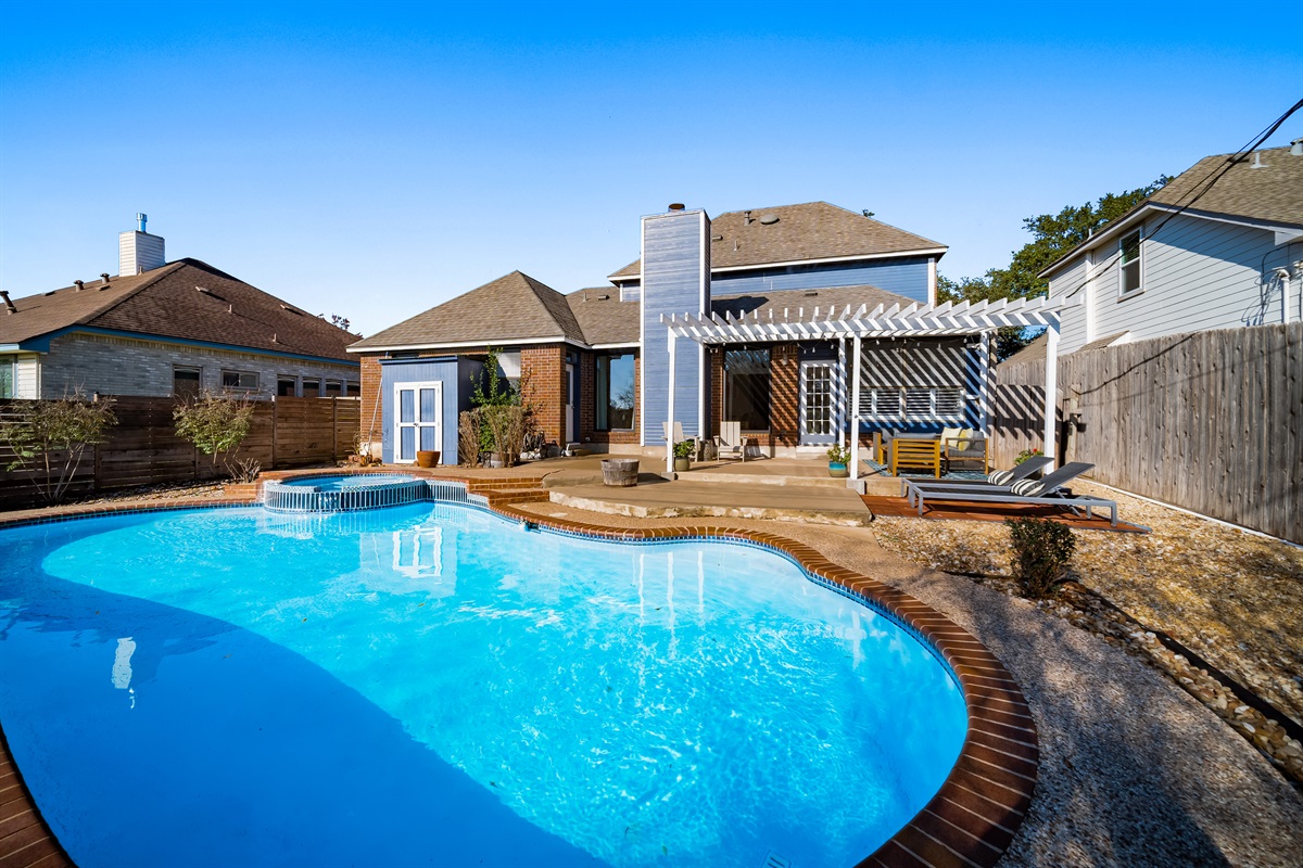 Pool sparkles, shade, jacuzzi—your serene backyard escape.