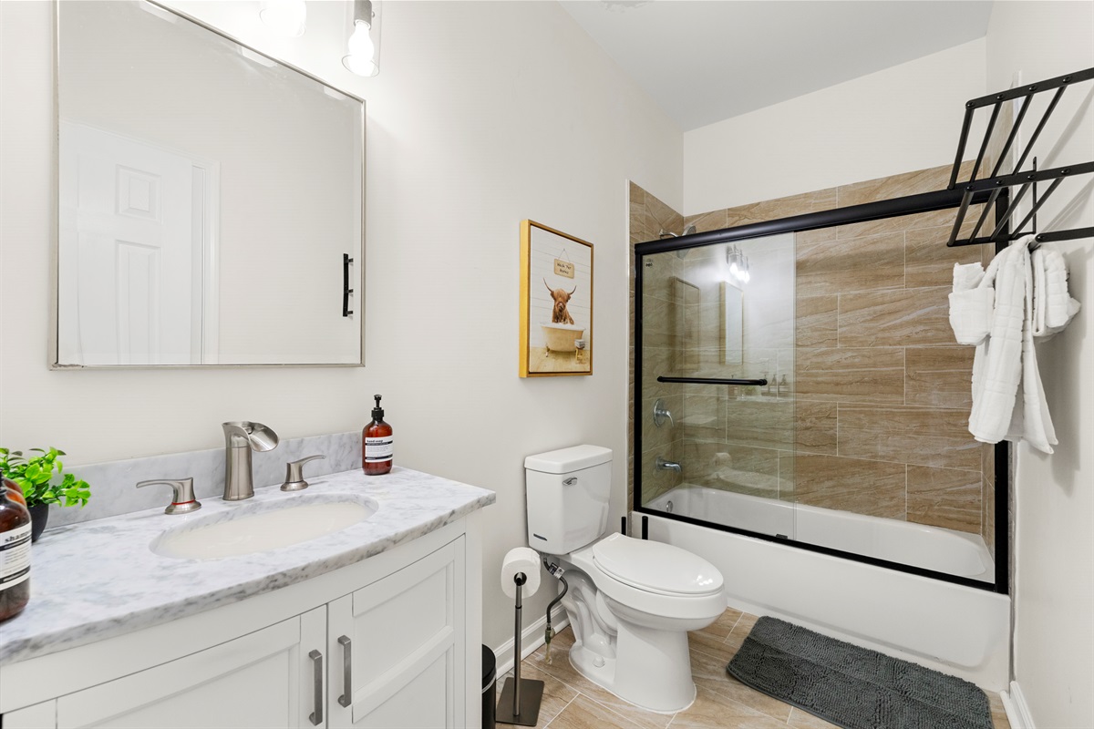 Freshen up in this modern bathroom with a deep tub and elegant finishes.