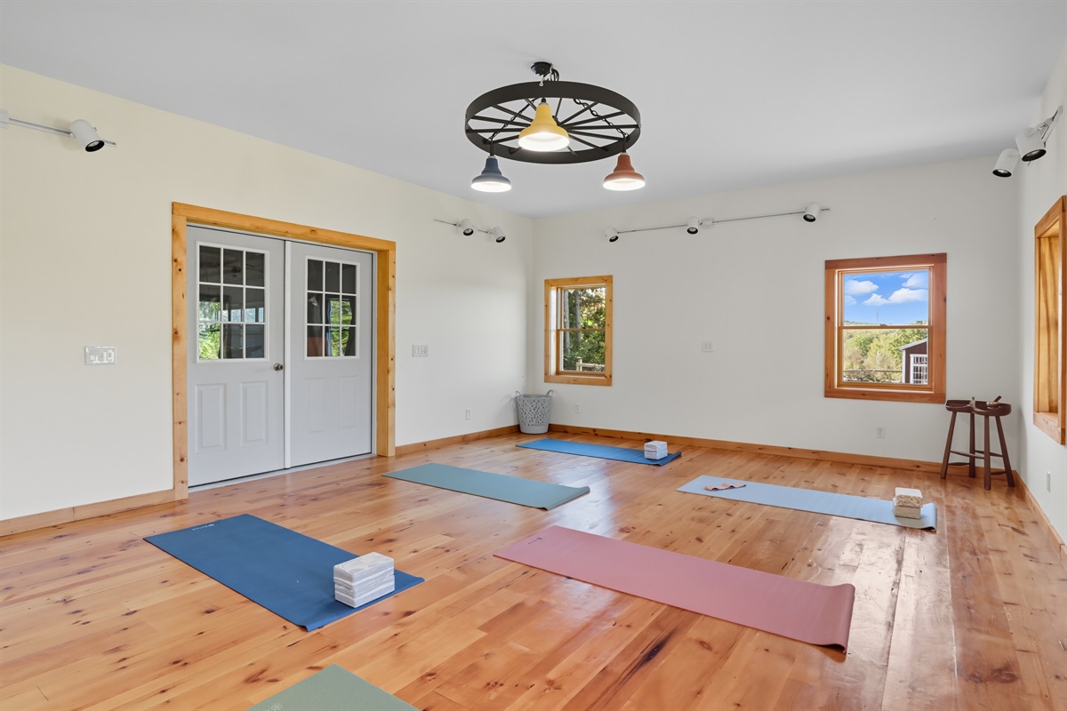 Sunlit multipurpose room with double doors.