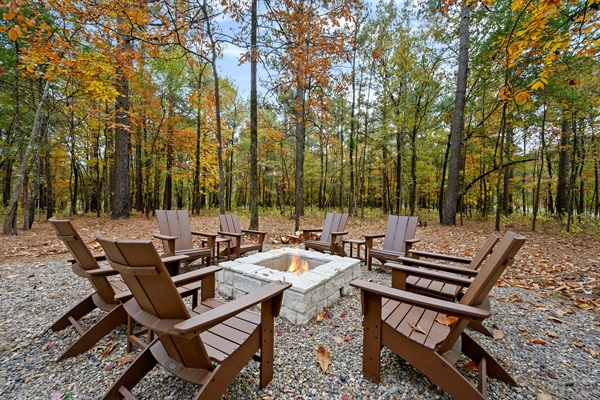 Spacious outdoor fire pit with Adirondack seating and peaceful forest views—perfect for s’mores, conversations, and relaxing evenings during your Broken Bow stay. 🌲🔥