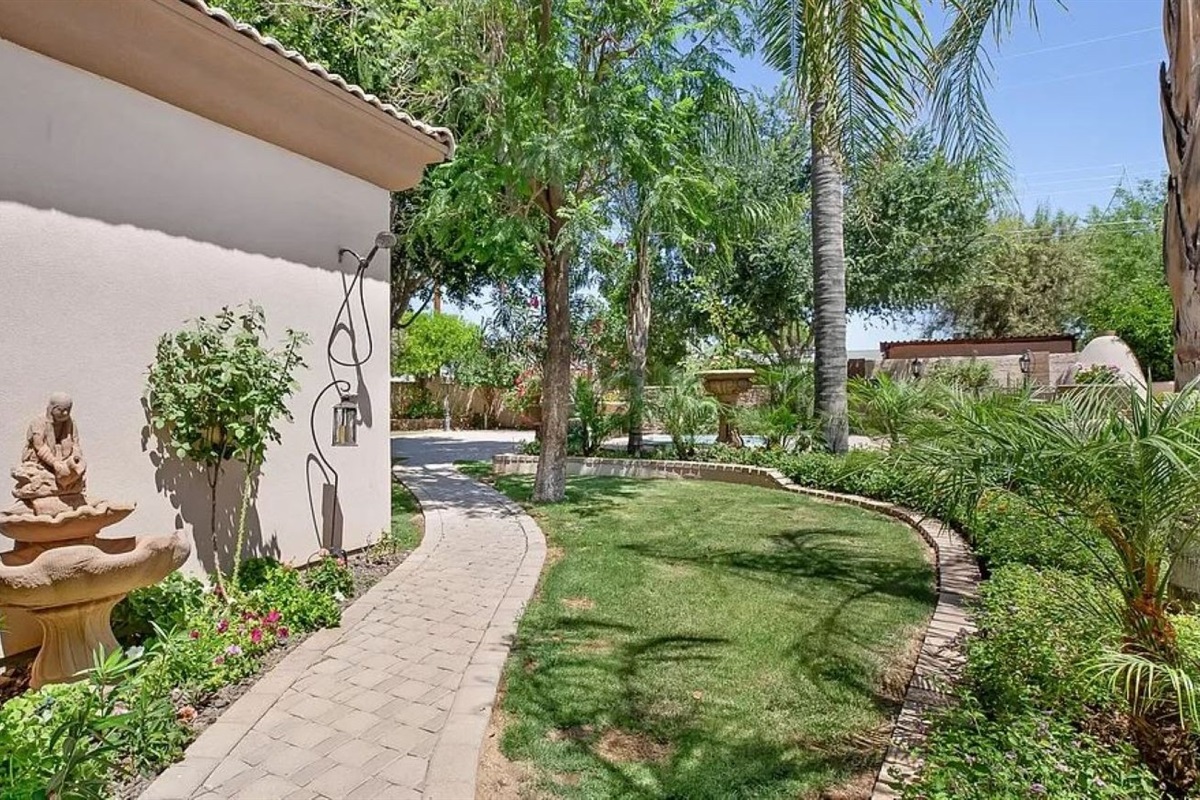 Stroll through this tranquil garden path framed by tropical greenery and desert charm, the perfect start to your peaceful escape.