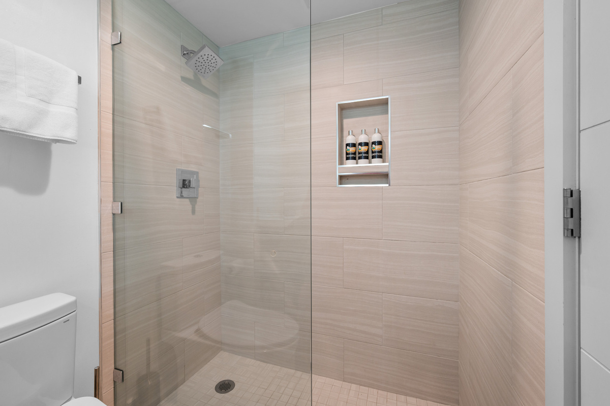 Walk-in tiled shower in the main-level bathroom.