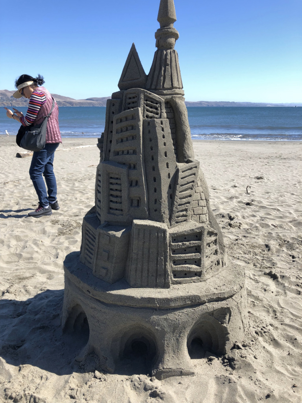 An elaborate sandcastle built on the beach