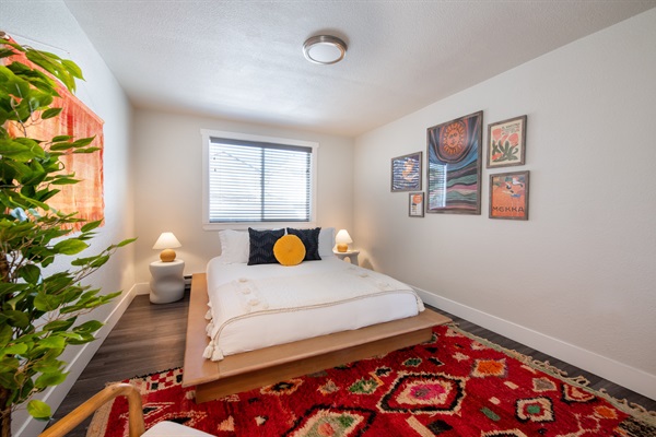 Sleek bedroom and art for bedroom 2 near back of home and facing backyard