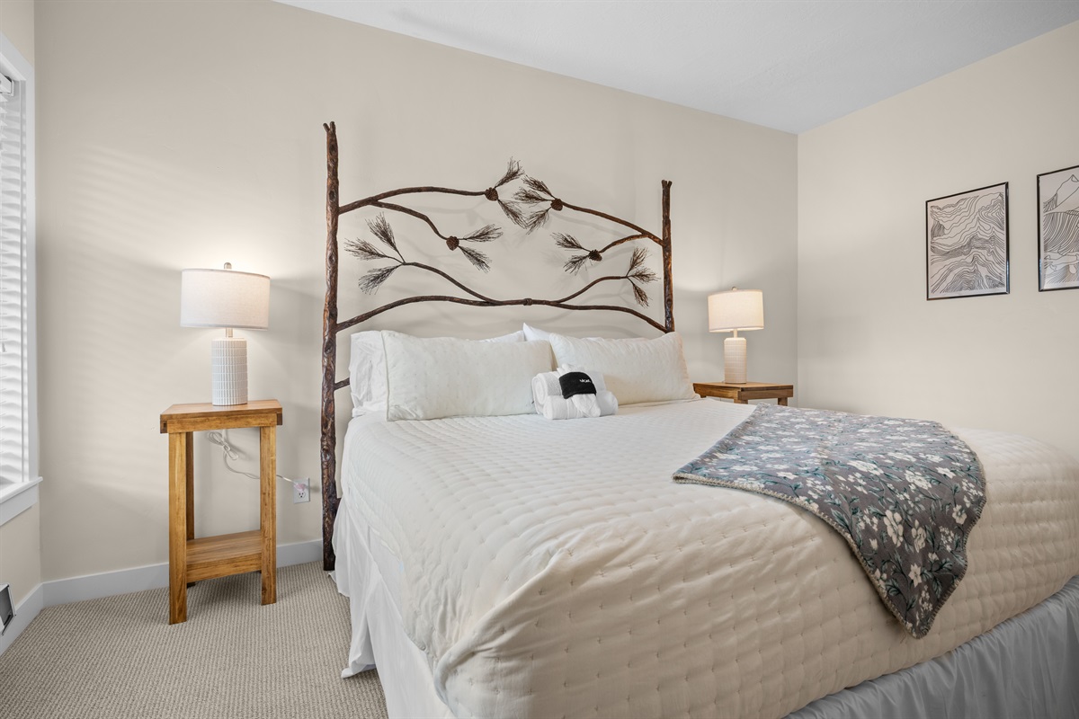 Comfortable king bedroom with cozy linens and a relaxing atmosphere.