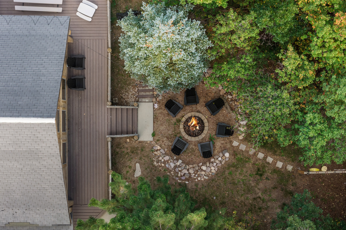 Top-down aerial view showing the fire pit nestled directly beside the cabin.