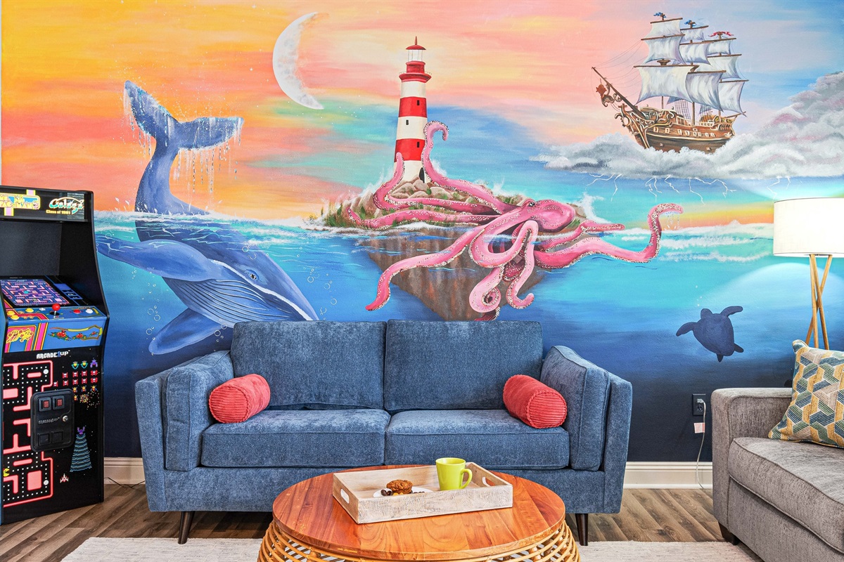 Kick back under the whimsical ocean mural with Pac-Man ready to play