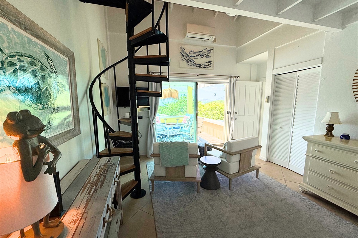 The first guest room is located off of the kitchen, near the dining table.  The spiral steps bring you the loft which has a queen bed.
