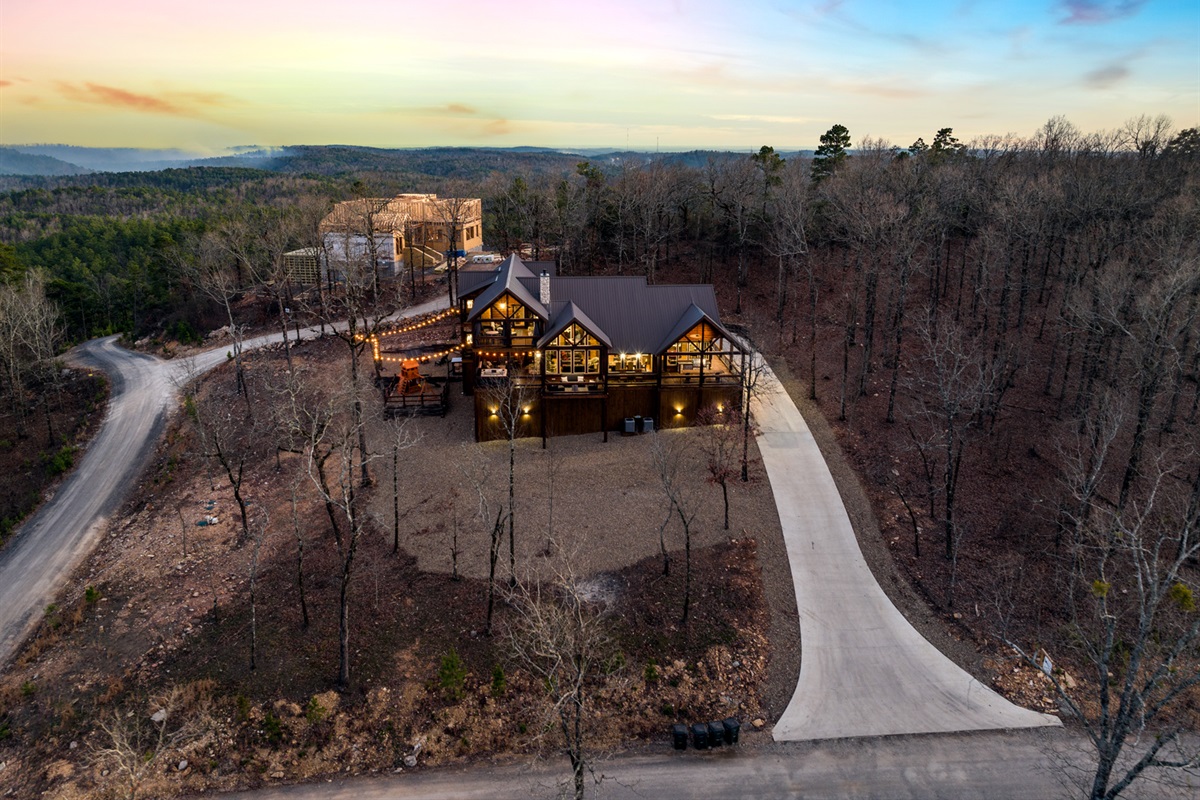 Aerial view showcasing the cabin’s private wooded setting and expansive layout