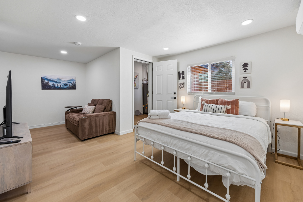 view of the super comfy queen sized bed from the vantage of the front door.