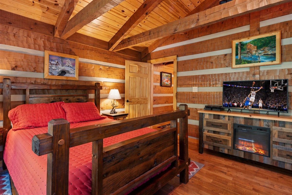 Smart TV and electric fireplace in the large bedroom