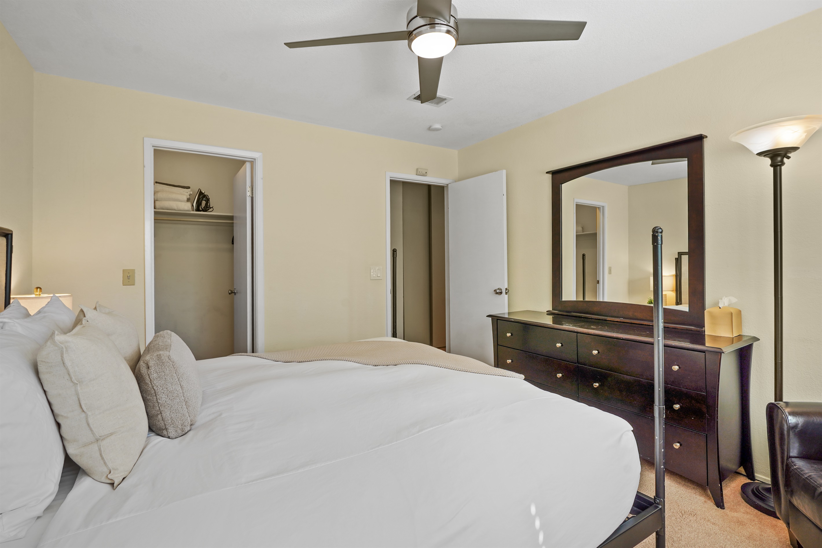 Relax and recharge in this cozy guest bedroom featuring a comfortable queen bed and calming, modern touches.