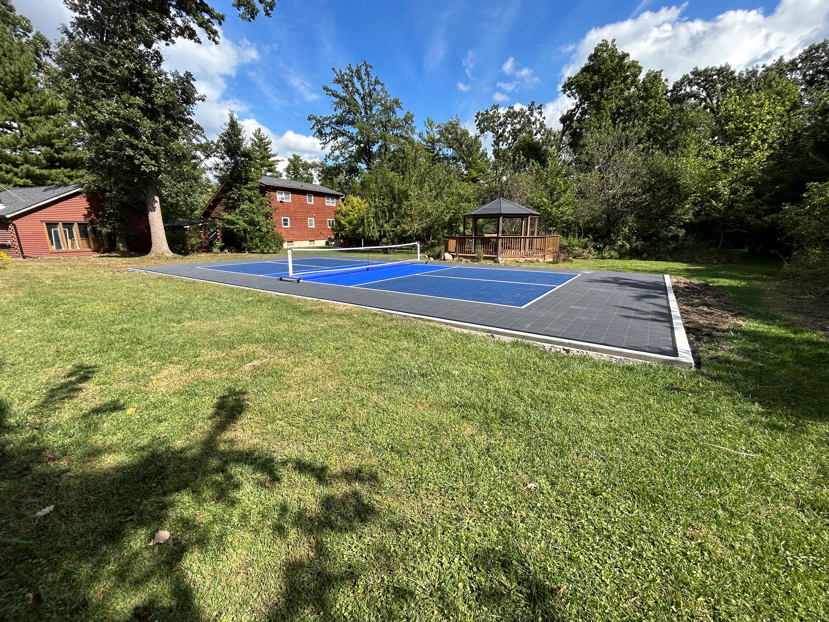 Spend hours playing on this private regulation sized pickleball court with a Sport Court surface.