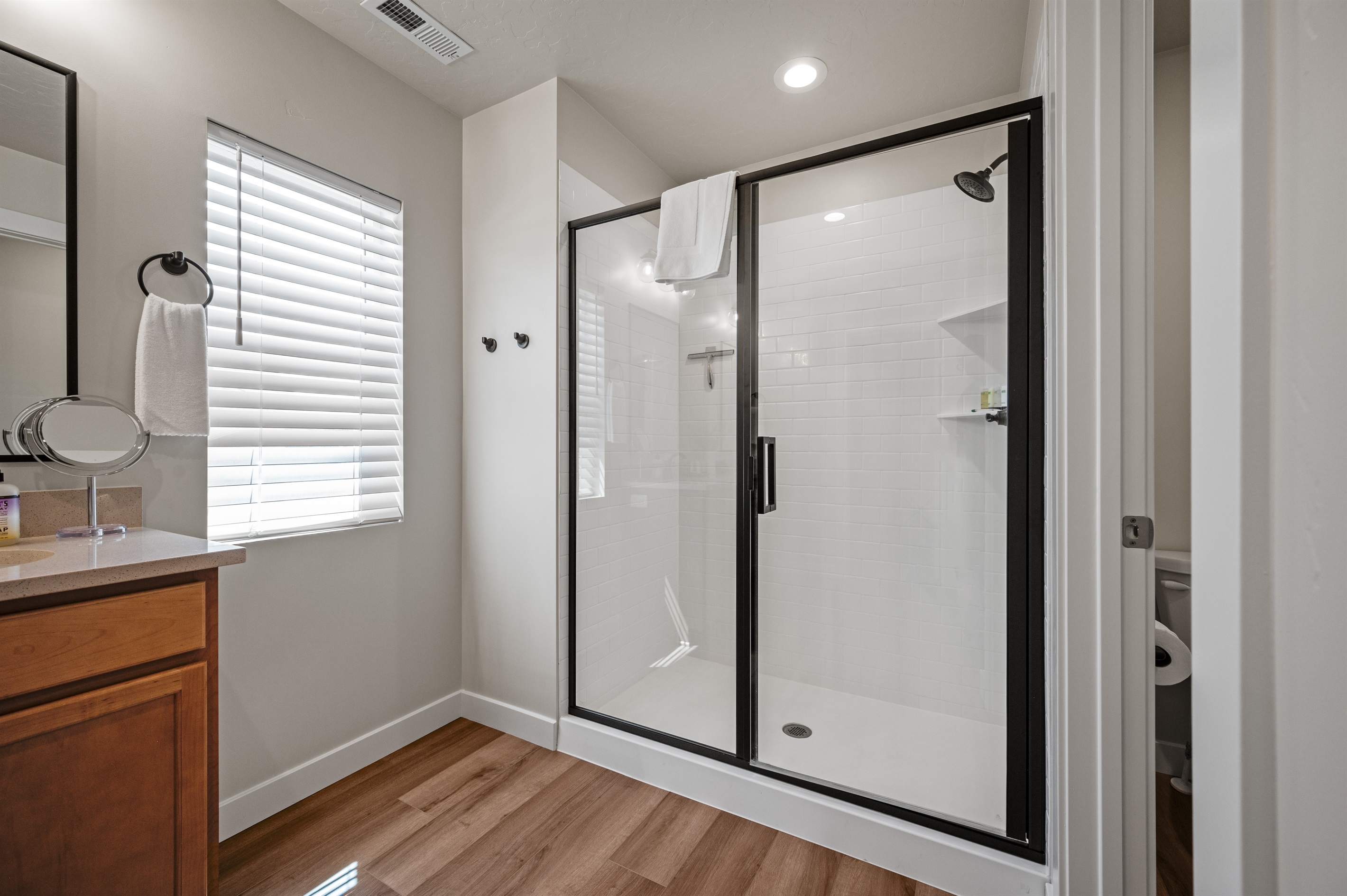 Refresh in the large glass-enclosed shower, complete with shelving for your toiletries and spa-like comfort.