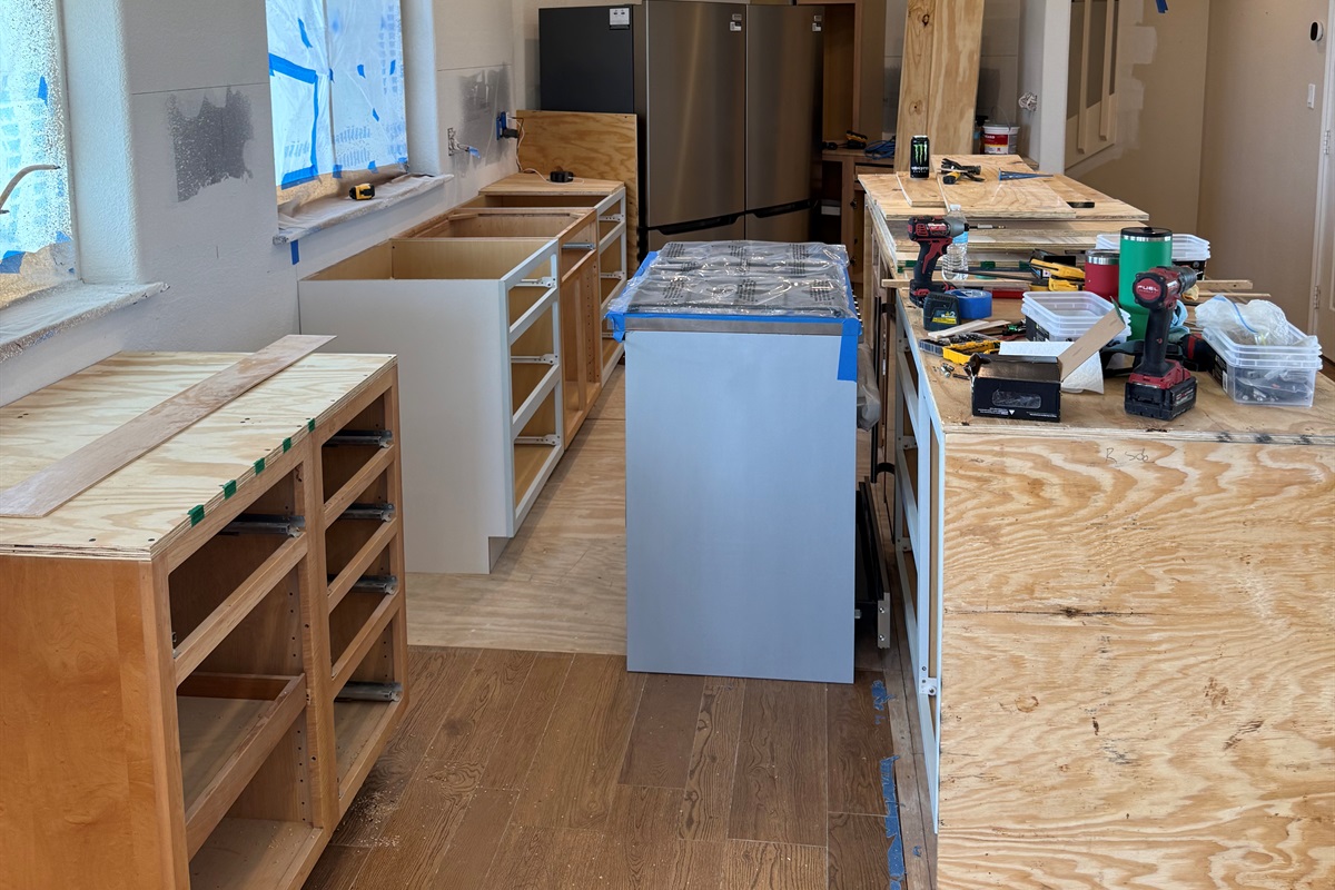 Kitchen in progress with the 6 burner range in the aisle.  Countertops will be quartz. 