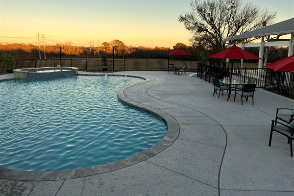 Resort style 30,000-gallon saltwater pool with double waterfalls and grotto and slide