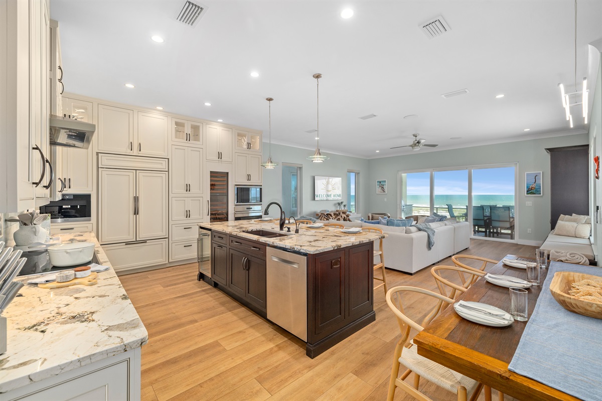 Open-concept layout with ocean views from the kitchen, dining, and living area