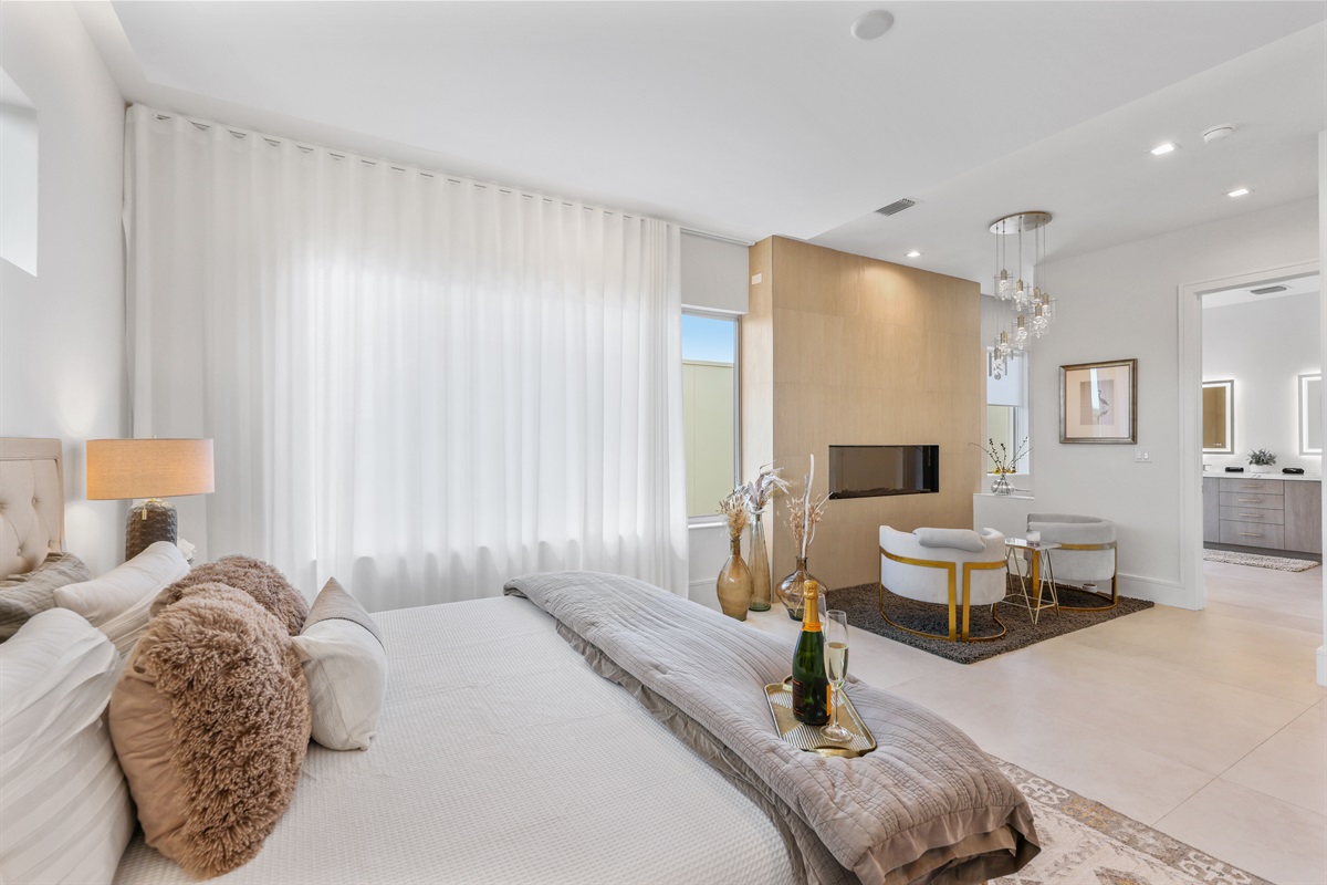 Upstairs primary suite – fireplace, walk-in closet, luxury bath, and 65” Smart TV for indulgent comfort.
