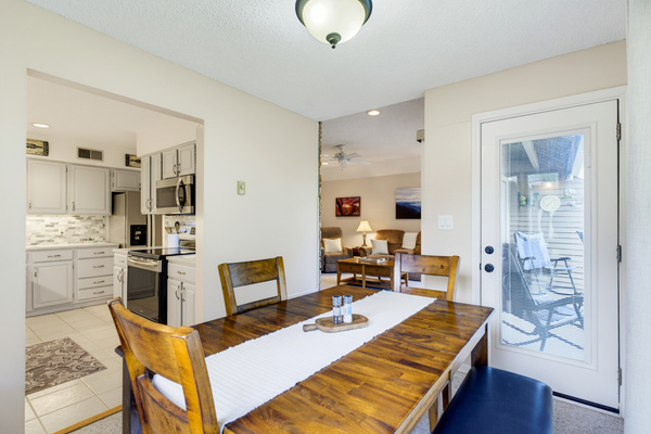 The dining room connects easily to the kitchen, living room, and covered partially deck.