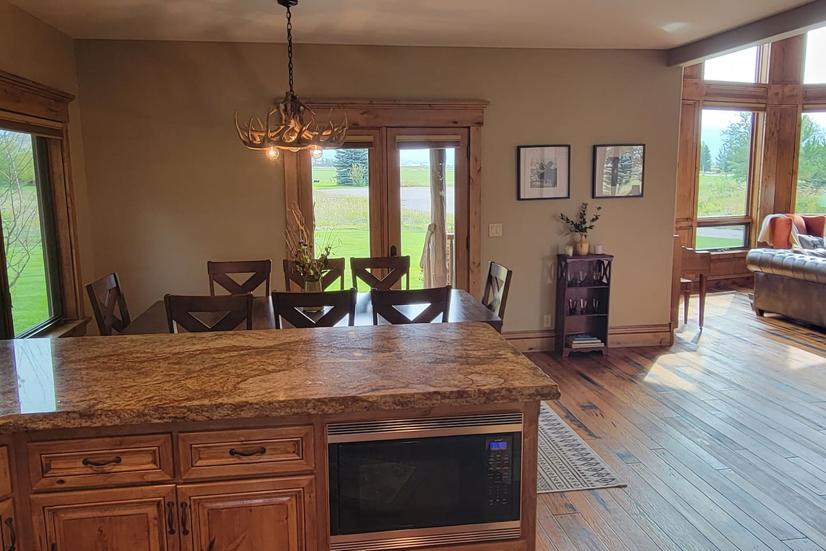 Enjoy a bright, open kitchen and dining space designed for connection, featuring a spacious island, comfortable dining area, and natural light with beautiful views just outside.