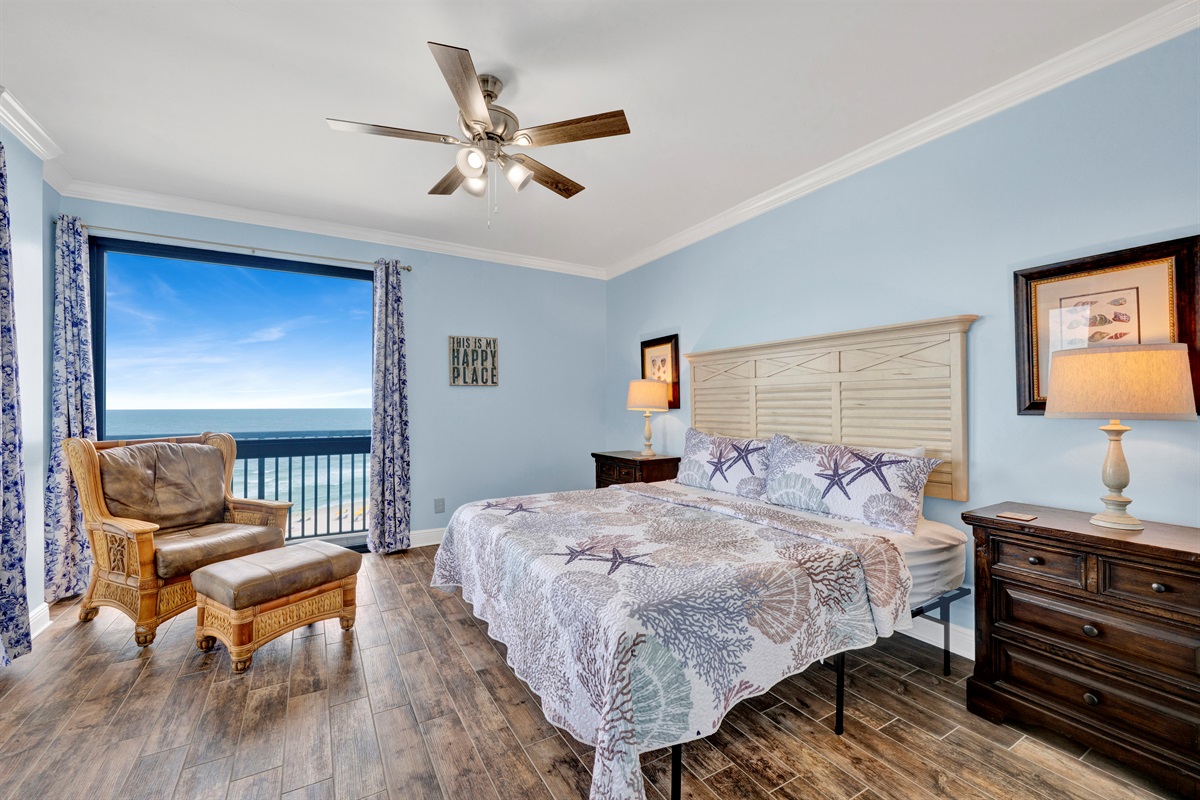 Primary bedroom with king bed, ceiling fan, wall mounted smart TV, direct balcony access and AMAZING view!