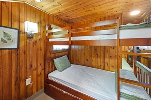 Twin bunk bed with white and green linings